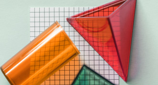 Image of Three plastic shapes on top of drawing paper
