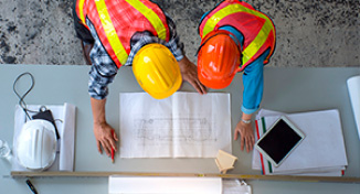 Image of Workmen looking over building plans